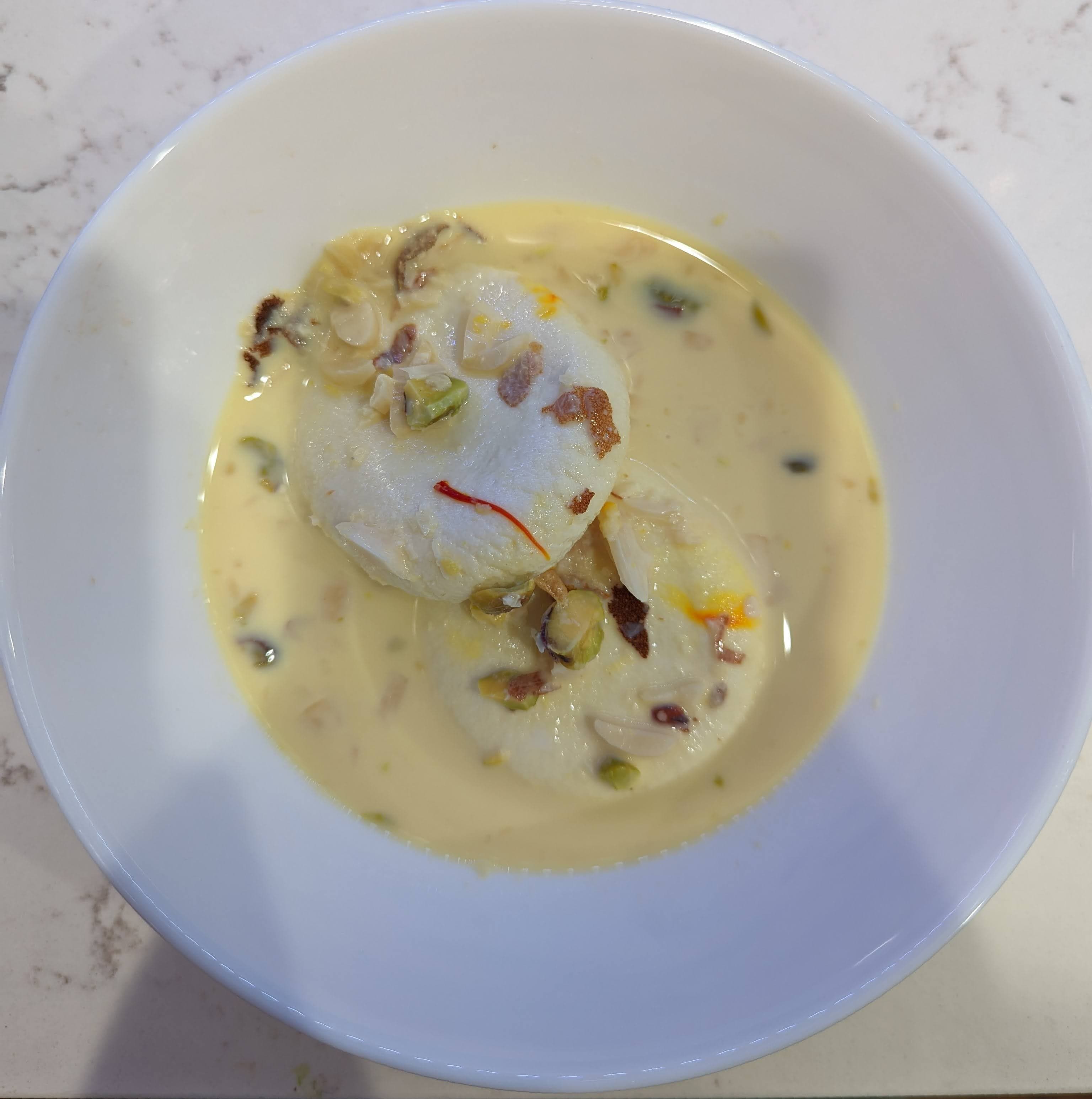 Homemade rasmalai in cardamom milk